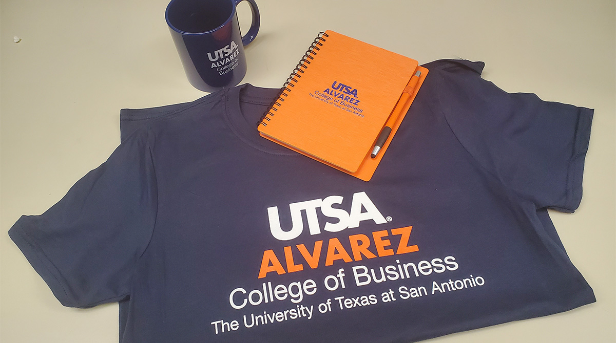 Picture of branded t-shirt, mug and notebook.