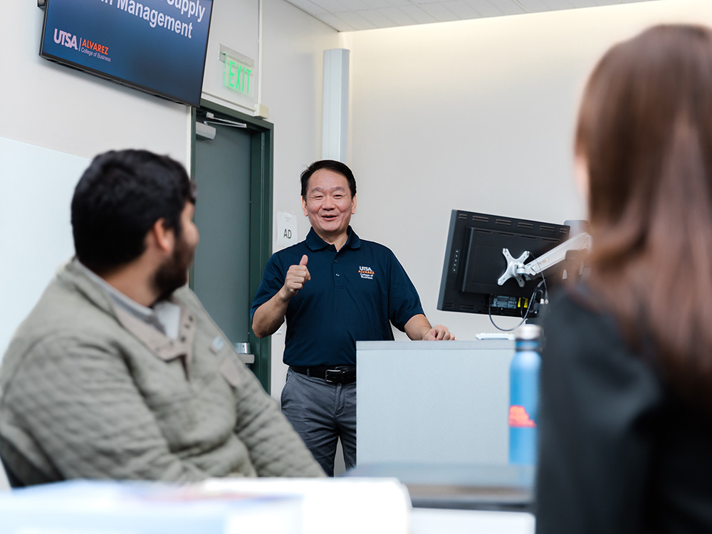 faculty member talking to students in a classroom