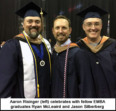 Aaron Risinger celebrates with fellow EMBA graduates Ryan McLeaird and Jason Silberberg