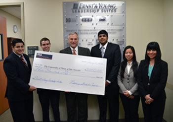 Business Student Council members present check to Dean Sanders