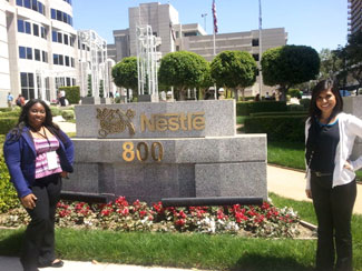 Photo of Michelle Banks and Salma Mendez outside Nestle headquarters sign