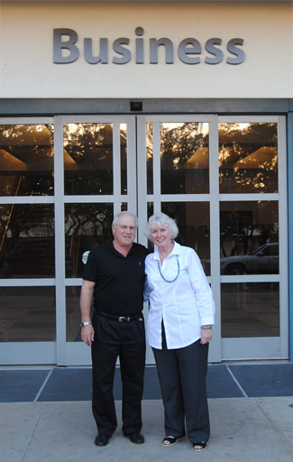 Mike and Brigitte Perkins standing in front of the Business Building