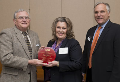 Tracy Jackson receives award from Jim Groff and Gerry Sanders