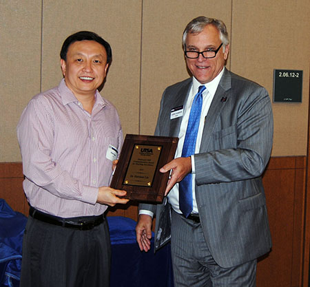 Harrison Liu receiving his award from Dean Gerry Sanders.