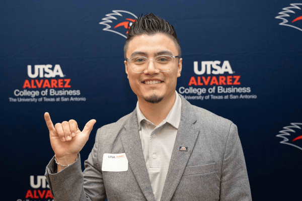 Alvarez Mentor holding up a "Birds Up" hand sign 