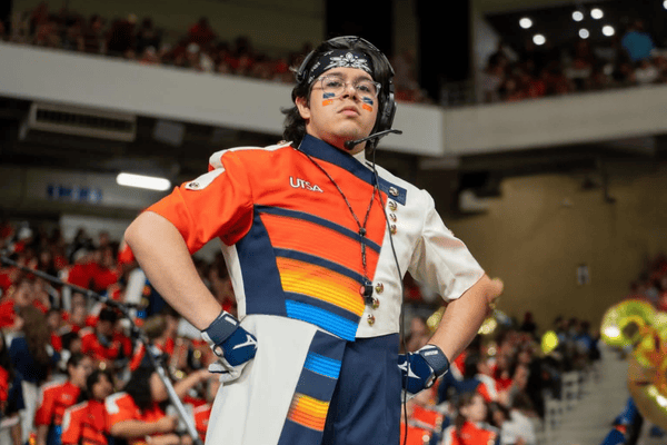 Assistant Drum Major of the Spirit of San Antonio Marching Band, Adrian Vasquez-Mora, leads the band at the Alamodome.