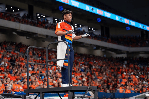 Spirit of San Antonio Marching Band Head Drum Major, Gabriel Perez, conducts at the Alamodome.