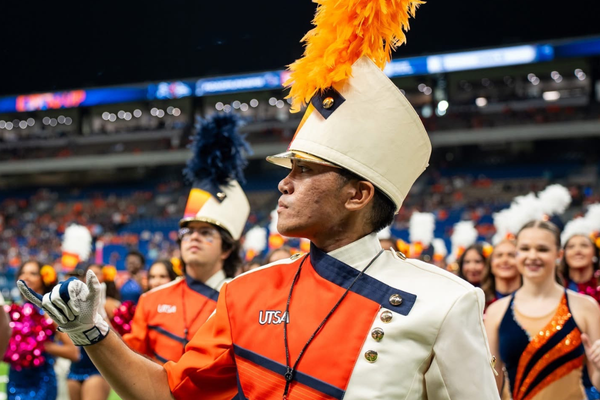 Spirit of San Antonio Marching Band Head Drum Major, Gabriel Perez (center), and Assistant Drum Major, Adrian Vasquez-Mora (left), prepare to lead the band on the Alamodome field.
