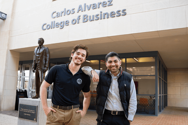 Carson Cowan (left) with fellow graduate and Investment Society member Sebastian Gallegos (right).