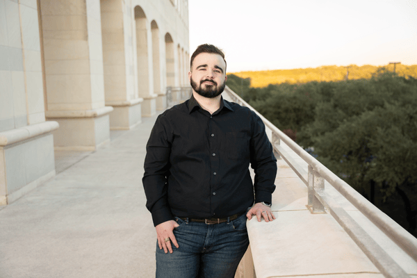 Kolby Porter, MA Economics '25, poses on a balcony.
