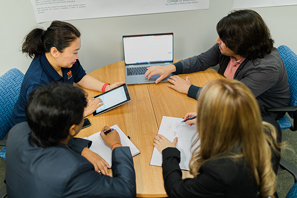 Students studying in the graduate business commons.